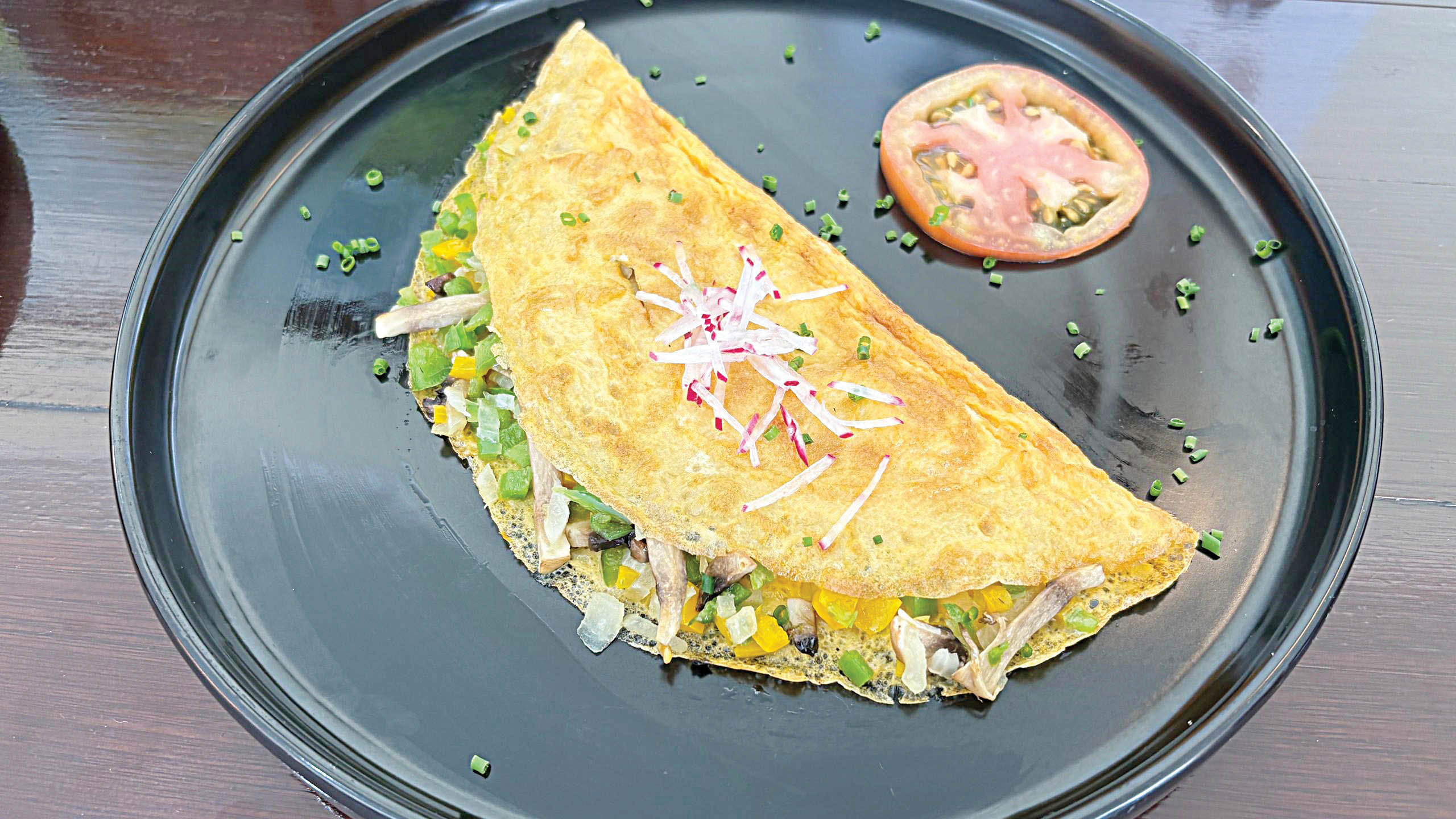 Eggs Benedict, a perfectly poached eggs resting on toasted English muffins with a silky hollandaise sauce. Fluffy omelette made to your liking.